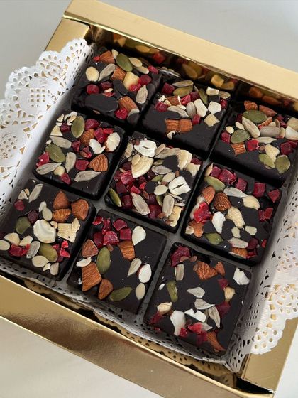 A close-up of my fruit and nut chocolate bark. It's loaded with almonds, cashews, pumpkin seeds, and dried berries for a crunchy and healthy treat.