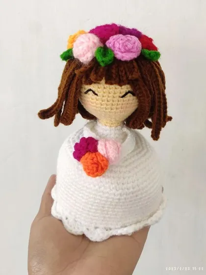 This doll is designed to look like a beautiful flower bouquet herself, with a white dress and a colorful floral crown.