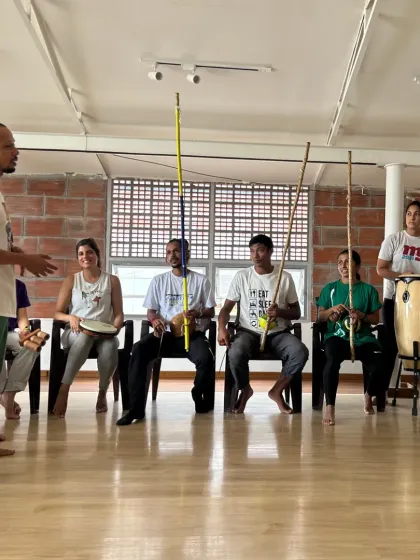 An instructor leads a music session during the Batizado. His passion for the music is contagious, inspiring everyone to join in.