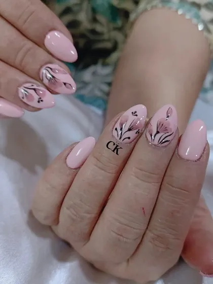 Another angle of the hand-painted floral nails, showing the subtle details and shading that bring the flowers to life.