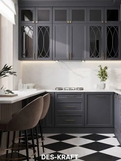 A classic black and white checkered floor provides a timeless foundation for this modern kitchen. We designed custom dark navy cabinetry with elegant glass and brass details, creating a sophisticated culinary space that is perfect for both cooking and entertaining.