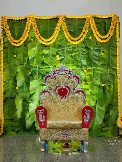 I love working with traditional elements to create something beautiful. This backdrop uses fresh banana leaves and bright yellow marigold garlands, a perfect and auspicious setup for ceremonies like a baby shower or a naming ceremony.