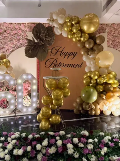 This celebration was a dual milestone, a 60th birthday and a retirement party. I designed a sophisticated setup with a beautiful floral wall, a gold-toned balloon arch, and a large marquee '60' to honour a lifetime of achievements in style.
