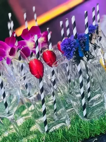 Simple elegance can make a statement. These champagne flutes are ready for guests, detailed with floral garnishes and custom 'BarJockey' stirrers, showing how I prep for a seamless and beautiful service.