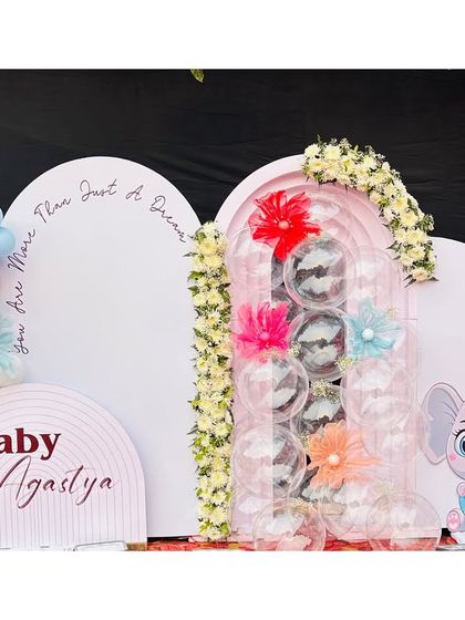 A full view of the Kuan Pujan ceremony decor. The design incorporates unique elements like a clear column filled with silver balls, adding a touch of modern flair to the celebration.
