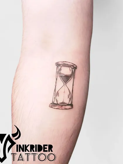 An hourglass tattoo, symbolizing the passage of time. This small, detailed piece is a reminder to make every moment count.