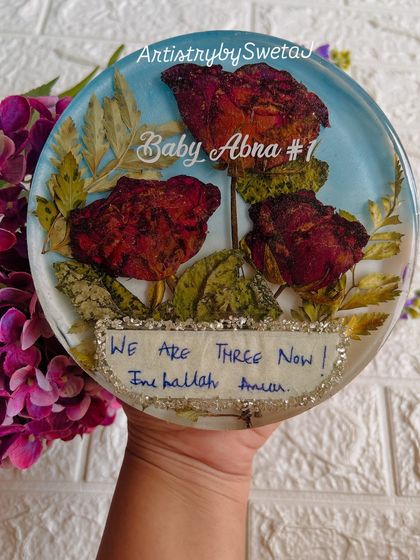 The finished keepsake, with the preserved roses and the special note sealed together forever. It’s a beautiful tribute to a growing family.