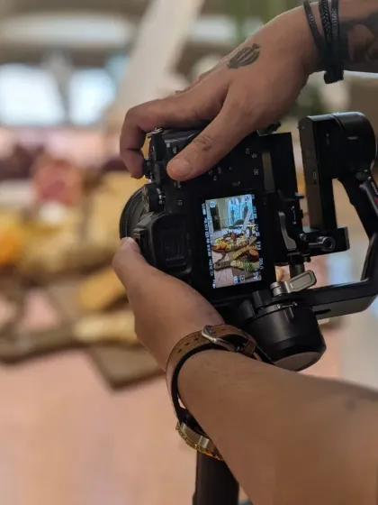 A behind-the-scenes look at the videographer capturing the vibrant grazing table at the GAIA boutique launch. The focus is on creating dynamic and appealing visuals.