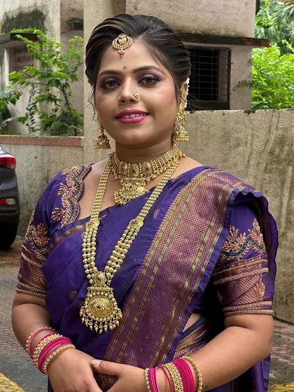 A full view of the makeup and styling for a traditional look, showing how the colors of the makeup complement the saree.