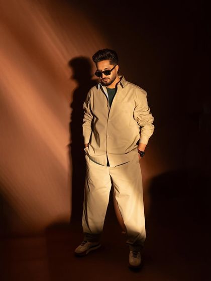 A full-length shot of singer and actor Jassie Gill, showcasing a relaxed, cool, and stylish look for the 'Wild Wild Punjab' promotions.