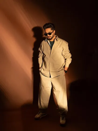 A full-length shot of singer and actor Jassie Gill, showcasing a relaxed, cool, and stylish look for the 'Wild Wild Punjab' promotions.