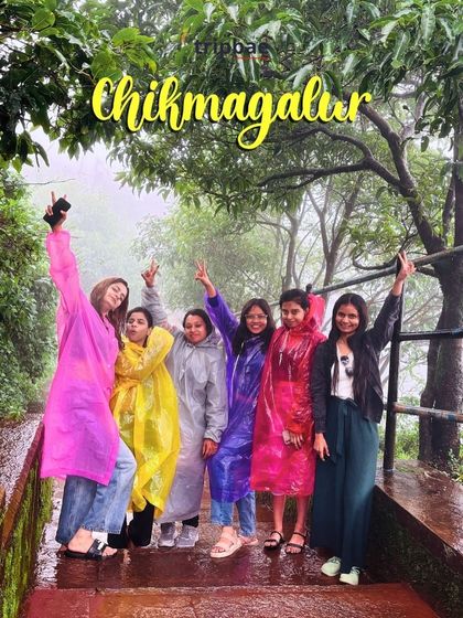 A group of girls posing with victory signs during a rainy Chikmagalur trek. Our trips are very popular among solo female travelers and groups of friends.