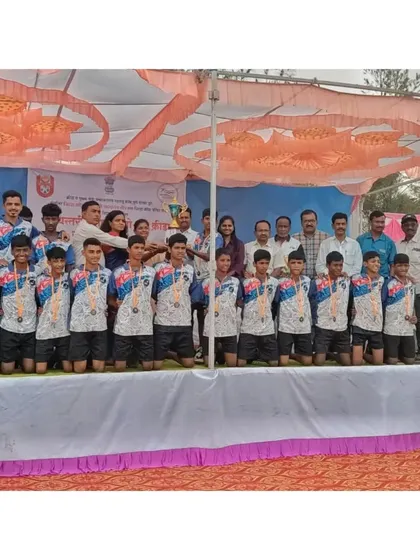 The team on stage receiving their trophy at the state-level competition in Beed.