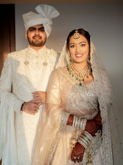 A regal portrait of the bride and groom. Her glowing skin and elegant jewelry stand out against the beautiful ivory ensemble.