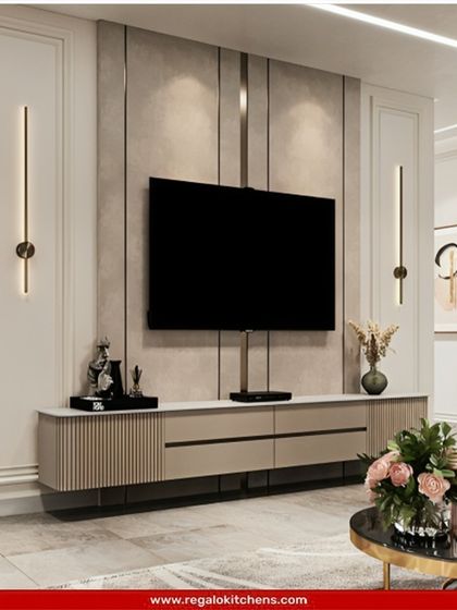 An elegant and symmetrical TV unit with fluted cabinets and classic wall sconces. The design balances modern textures with timeless style.