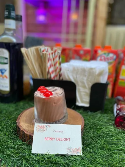 The Berry Delight mocktail, a sweet and fruity concoction topped with cherries. It's a popular choice for birthday parties and baby showers.