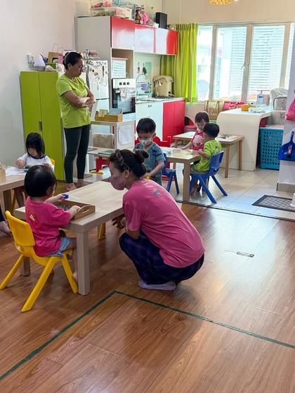 A typical scene from a classroom we support, where teachers guide children with respect and gentle observation. Our goal is to help educators create an atmosphere of calm, focused work.