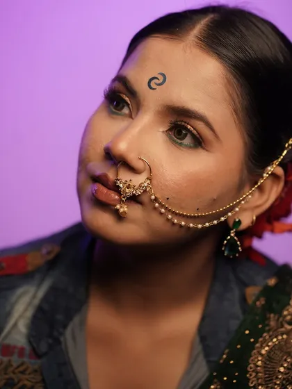 A close-up of the unfiltered editorial glam look. The unique forehead art and sharp eye makeup demonstrate the creative and precise techniques taught in our pro courses.