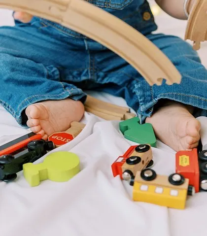 A close-up of the wooden train set from the themed birthday shoot, showing how we can personalize the session around your child's interests.