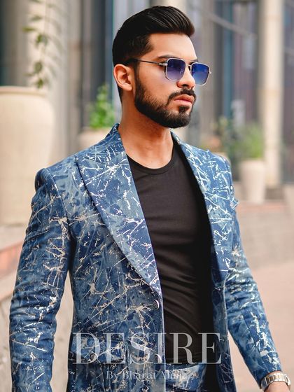 A confident profile in the blue splatter-print suit. The bold pattern is balanced by a classic tailored fit, creating a look that is both artistic and masculine.