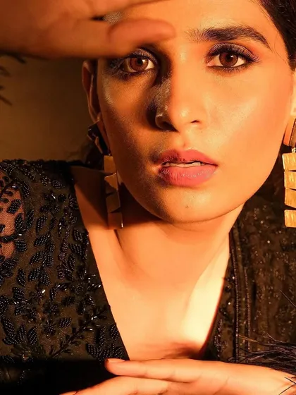 A close-up of the moody campaign look, showing the soft brown tones on the eyes and the natural, matte lip color. This style of makeup is designed to enhance features without overpowering the frame.