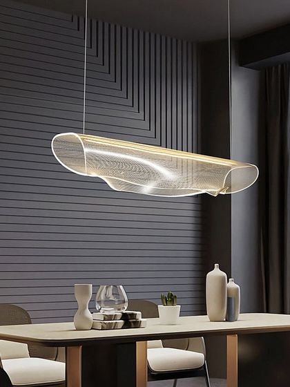 A linear suspension light with a beautiful, wave-like acrylic diffuser. It provides excellent, even lighting for a dining table or workspace.