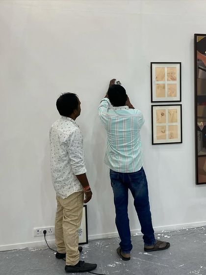 Installing smaller framed works requires precision and a good eye for composition.