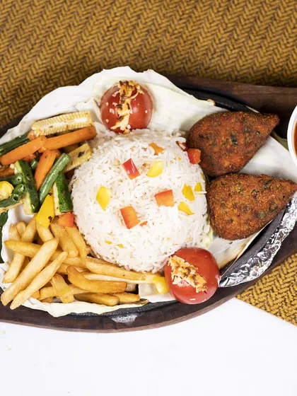 This sizzler is perfect for sharing with friends and family. It's loaded with vegetable cutlets, rice, fries, and grilled veggies, all served on a sizzling hot plate.