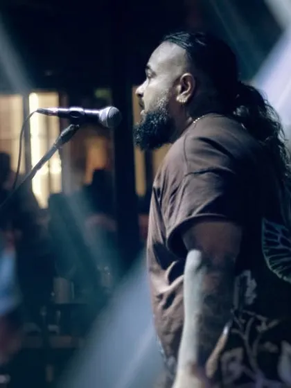 Another angle of our vocalist, commanding the stage. We use the entire space to engage with the audience and create a dynamic visual and auditory experience.