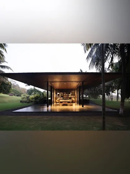 A tranquil pavilion at dusk, nestled within a vast lawn and palm grove. We designed this space as a quiet retreat, where the simple architecture is enhanced by the dramatic lighting and the natural beauty of the landscape.