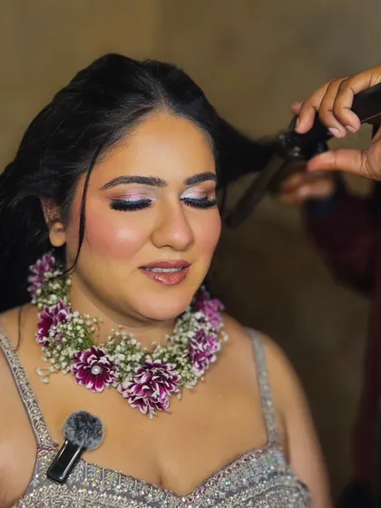 A candid moment while getting ready for the Haldi. We used a floral necklace to complement the rest of her jewelry.