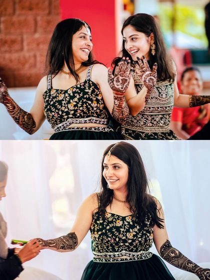 Capturing the fun and friendship during a Mehendi party, with the bride and her sister showing off their henna.