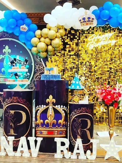For a royal celebration, this Prince theme uses a rich color palette of blue and gold. I created a stunning main stage with a gold shimmer wall, custom backdrops with crown motifs, themed cake plinths, and marquee letters spelling out the birthday boy's name.