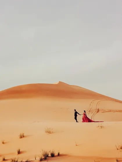 A grand, sweeping view of the Dubai desert. I positioned the couple to emphasize the vastness of the landscape, creating an epic and dramatic pre-wedding photograph.