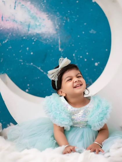 A dreamy moon and stars themed shoot. This little girl's joyful laugh makes it seem like she's truly floating on a cloud.