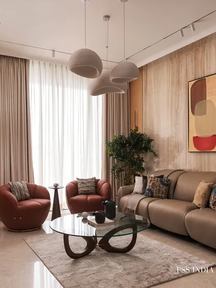 Soft tones and sculptural forms create effortless warmth in this living room. I brought together fluted wood panels, cozy textures, and organic curves to design a space that feels calm, modern, and deeply lived-in.