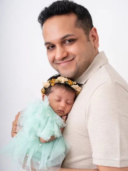 A father holding his baby girl close. The bond between a dad and his daughter is special from the very beginning.