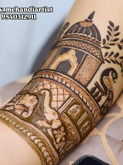 A close-up of an arm band featuring a royal elephant and a peacock inside a jharokha, showcasing my detailed motif work.