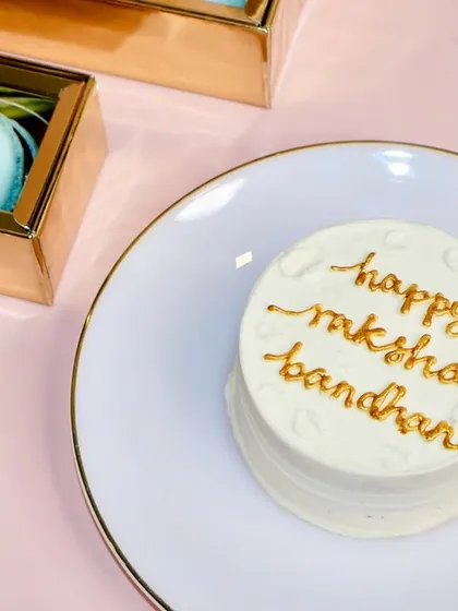 For a more traditional message, this elegant bento cake simply says "happy raksha bandhan" in beautiful golden script.