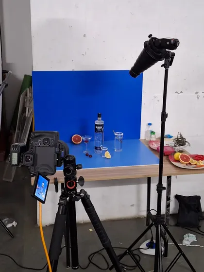 The complete studio setup for our premium vodka shoot, showing the camera, lighting, and blue backdrop.
