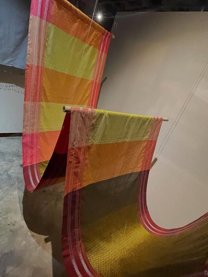 Colorful Ilkal sarees displayed at the 'Pampa - Textiles of Karnataka' exhibition. This traditional weave is a cornerstone of our state's textile heritage.