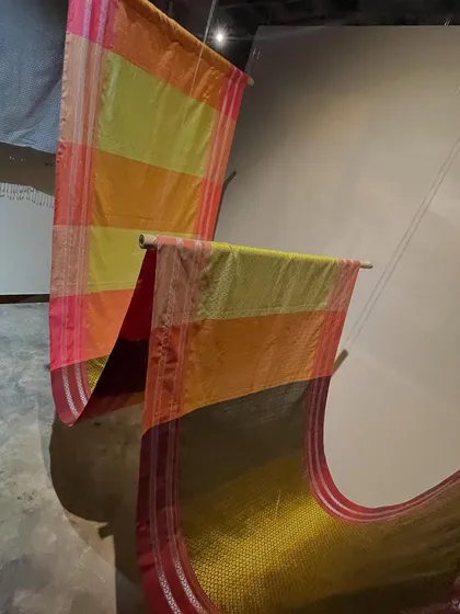More sarees on display at the Hampi exhibition, showcasing the vibrant colors and diverse weaving techniques found across Karnataka.