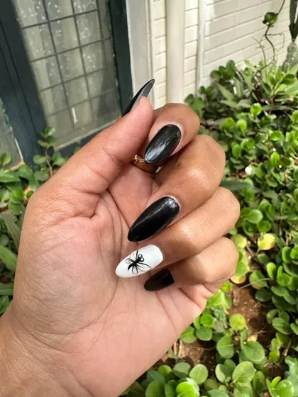 I can do wacky and fun designs too. This client wanted a dragonfly, and I hand-painted it on a white accent nail to contrast with the glossy black extensions.