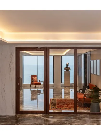 The entrance to The Office with a View at IHCL headquarters in Mumbai, where the lift lobby opens to a waiting area with an immediate, stunning glimpse of the ocean.