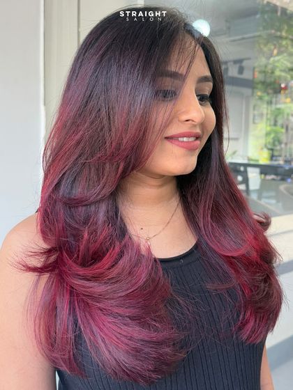 A beautiful portrait of the client, her smile radiating as much as her new vibrant hair color.