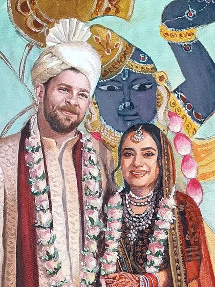 A close-up of the couple in the Pichwai-themed wedding painting, with the image of Shrinathji in the background.