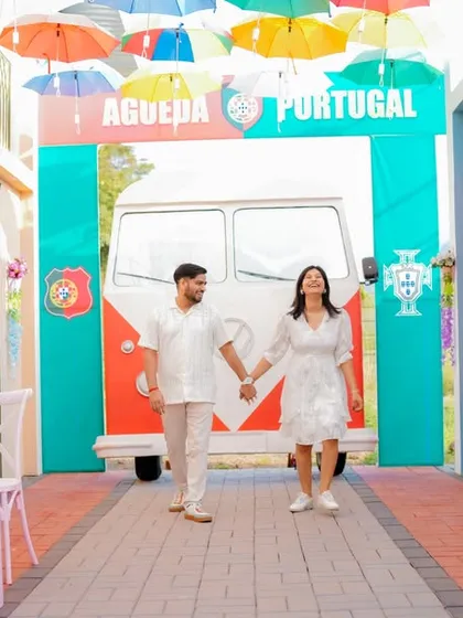 A fun, dynamic shot of the couple walking through a colorful, Portugal-themed alleyway. This set offers a unique and vibrant background for a pre-wedding shoot that feels like a European holiday.