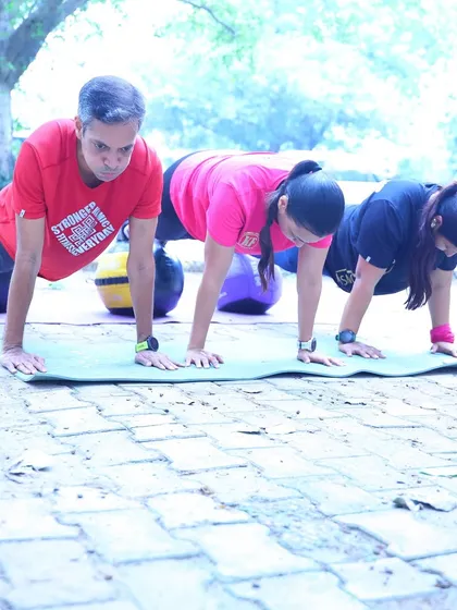 Athletes holding a plank, some with the added challenge of a stability ball. Core strength is the foundation of all movement.