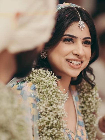 A close up portrait of the bride, showcasing the delicate makeup and her radiant smile.