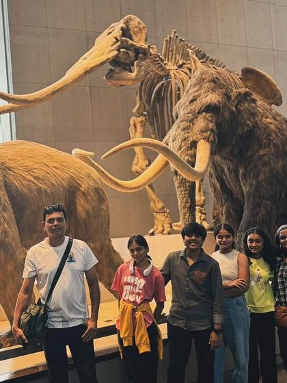 Posing with the mammoths! A fun group photo from our educational day out at the museum in Shanghai.